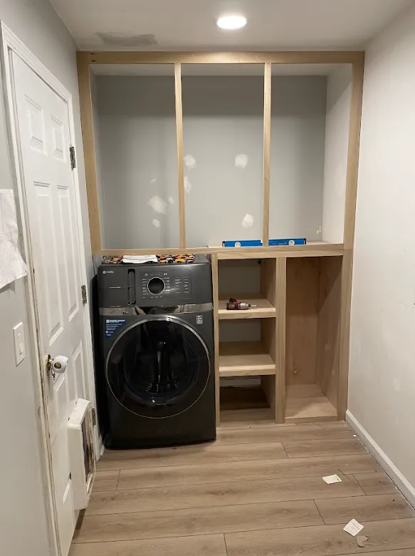 Custom shelving and cabinet framework being installed in a home