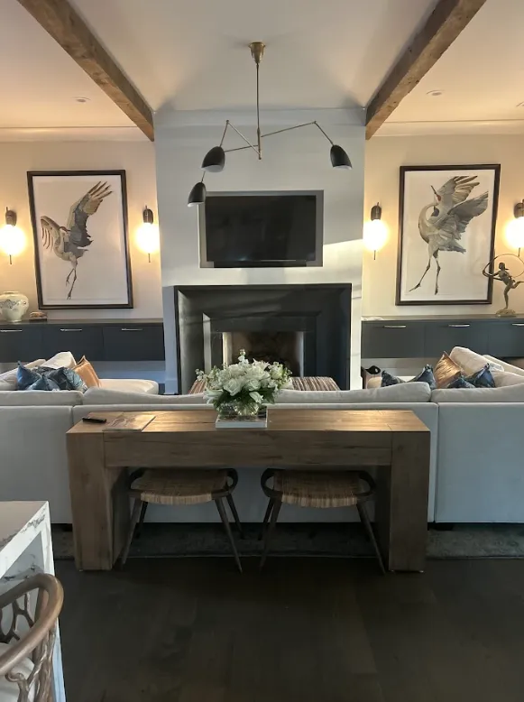 Beautifully styled living room with mounted TV, fireplace, and framed art installed by Picture Perfect HHI